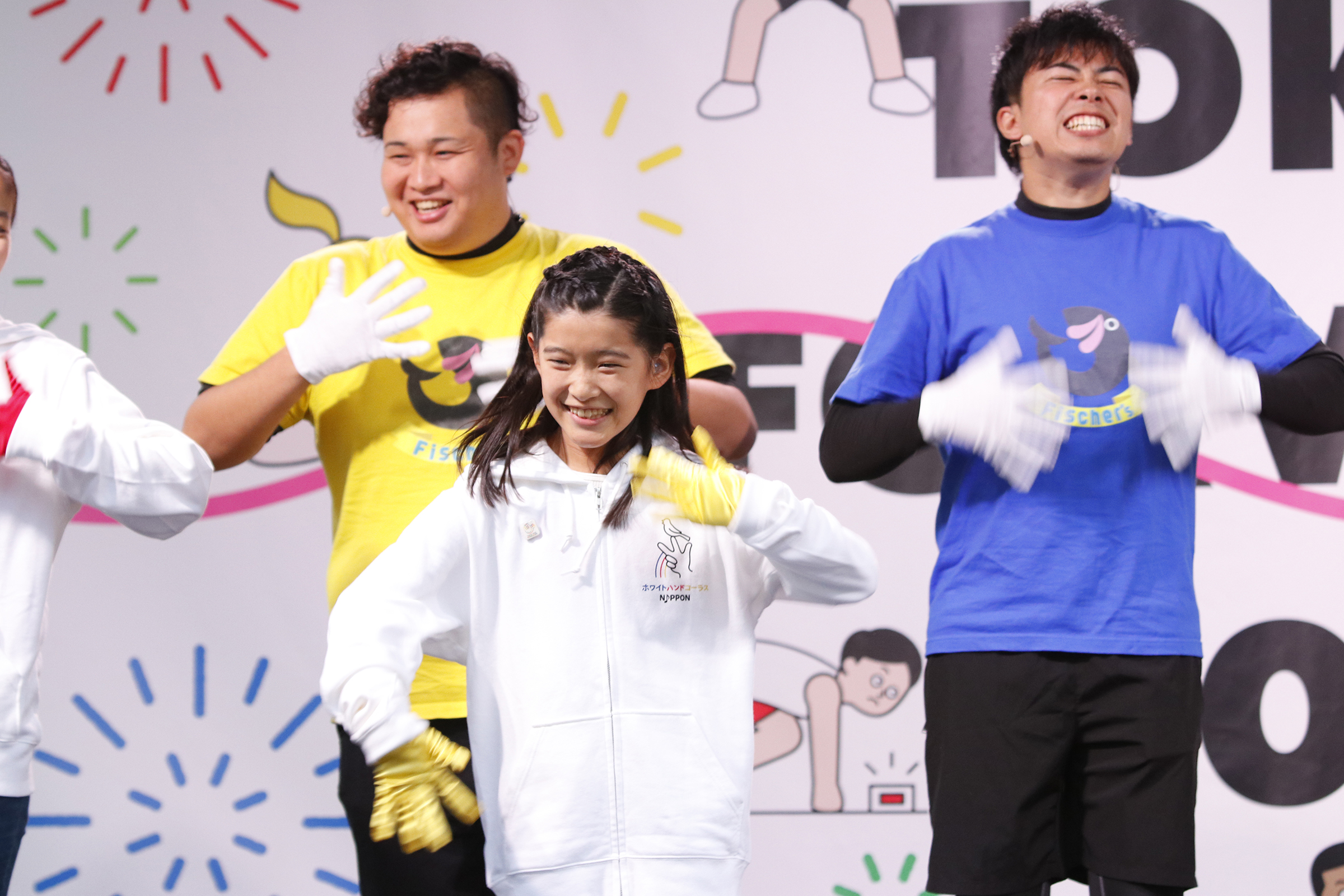 手歌をしている女の子とンダホさんとマサイさんの写真
